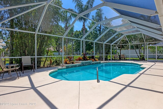 view of swimming pool with a lanai and a patio