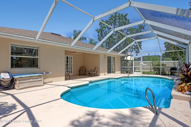 view of pool featuring ceiling fan, a lanai, and a patio