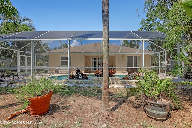 back of property with a lanai and a patio