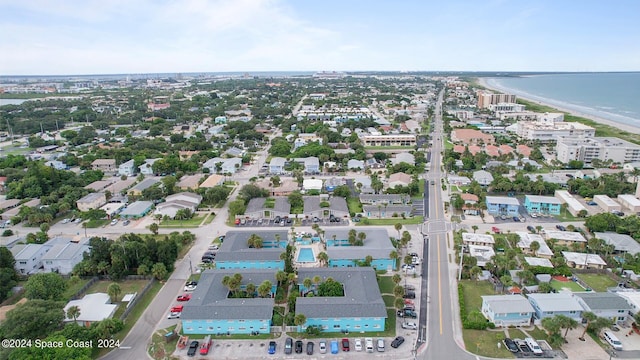 birds eye view of property with a water view and a view of the beach