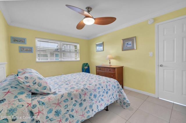 bedroom with a ceiling fan, crown molding, baseboards, and light tile patterned floors