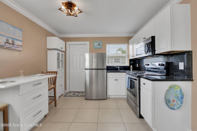 kitchen with appliances with stainless steel finishes, crown molding, a sink, and decorative backsplash