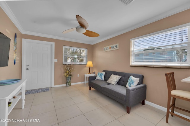 living room with crown molding, baseboards, and light tile patterned floors