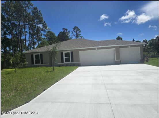 ranch-style home with a front yard and a garage