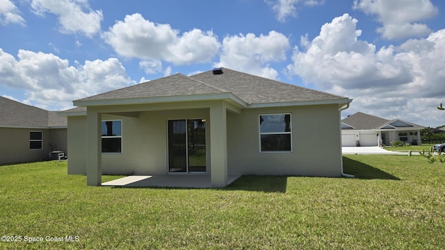 4376 Kelsey Ln, Sebastian, FL 32976 - rear view of house featuring roof with shingles, stucco siding, a lawn, and a patio area