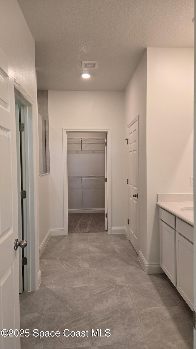 4376 Kelsey Ln, Sebastian, FL 32976 - hallway with a textured ceiling and baseboards