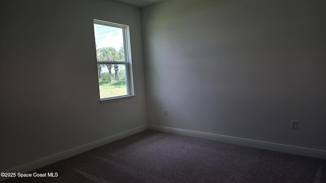 4376 Kelsey Ln, Sebastian, FL 32976 - unfurnished room with dark carpet and baseboards