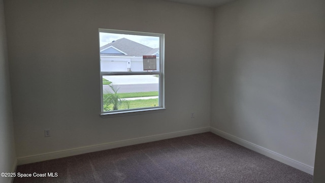 4376 Kelsey Ln, Sebastian, FL 32976 - unfurnished room with healthy amount of natural light and dark carpet
