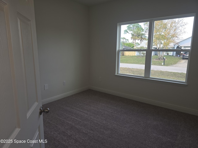 carpeted spare room featuring a healthy amount of sunlight