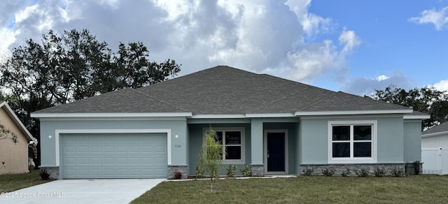 view of front of house with a garage and a front lawn