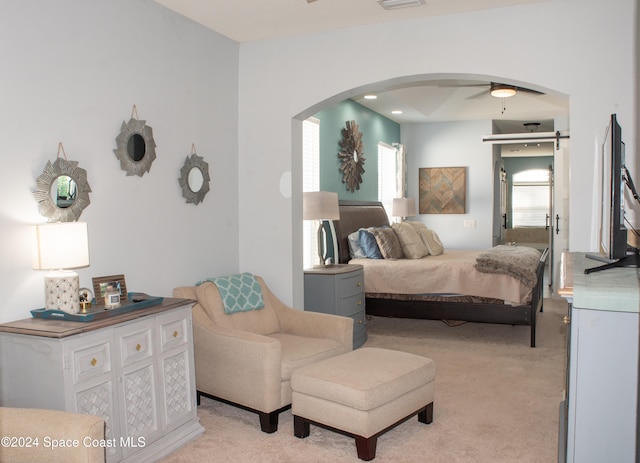 bedroom featuring light colored carpet and ceiling fan