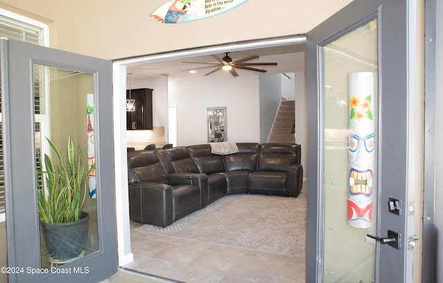 tiled living room with ceiling fan