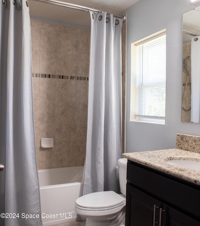 full bathroom with vanity, a healthy amount of sunlight, shower / tub combo, and toilet