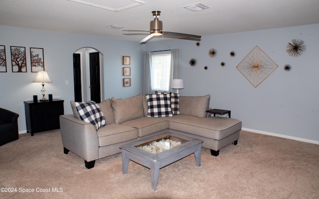 680 Easton Forest Cir SE, Palm Bay, FL 32909 - living room with light colored carpet, a ceiling fan, arched walkways, and baseboards