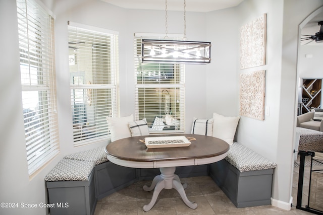 680 Easton Forest Cir SE, Palm Bay, FL 32909 - tiled dining room with breakfast area and a chandelier