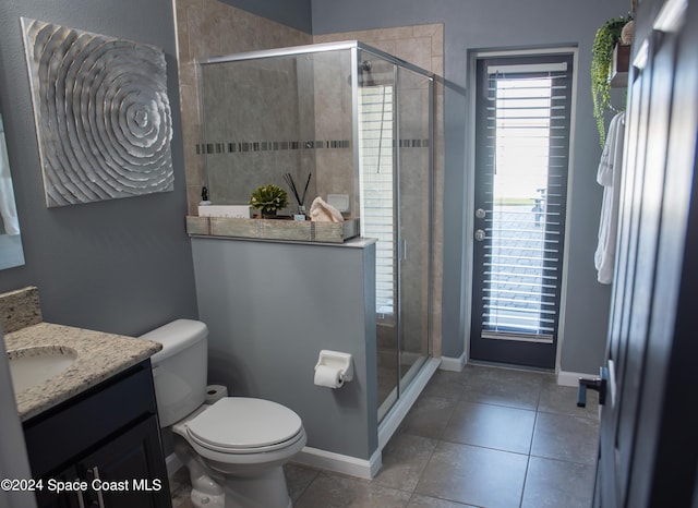 680 Easton Forest Cir SE, Palm Bay, FL 32909 - bathroom featuring toilet, vanity, tile patterned floors, and a shower stall