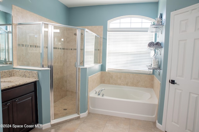 bathroom featuring tile patterned flooring, plus walk in shower, and vanity