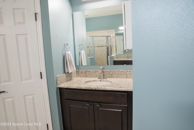 bathroom with vanity and an enclosed shower