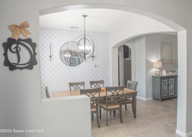 dining area featuring a notable chandelier