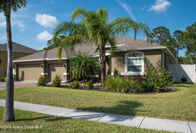 view of front of house with a garage and a front yard