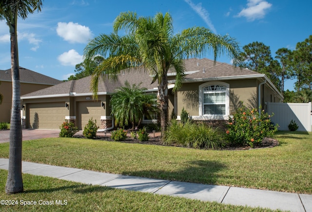 680 Easton Forest Cir SE, Palm Bay, FL 32909 - view of front of house with a garage, stucco siding, and driveway