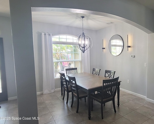 680 Easton Forest Cir SE, Palm Bay, FL 32909 - dining area featuring arched walkways, tile patterned floors, plenty of natural light, and baseboards