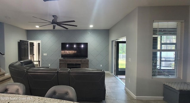 680 Easton Forest Cir SE, Palm Bay, FL 32909 - living area featuring a ceiling fan, wallpapered walls, baseboards, an accent wall, and stairway