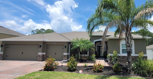 680 Easton Forest Cir SE, Palm Bay, FL 32909 - ranch-style house featuring stucco siding, an attached garage, decorative driveway, and stone siding
