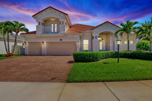 mediterranean / spanish house featuring a lawn