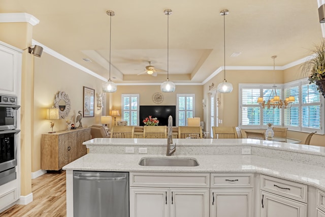 kitchen featuring stainless steel appliances, sink, white cabinetry, and a healthy amount of sunlight