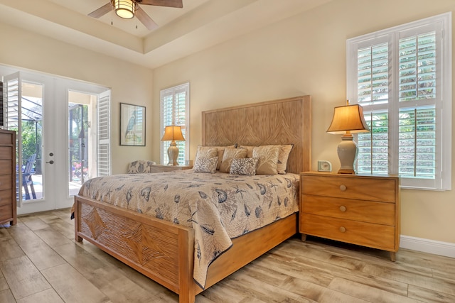 bedroom featuring ceiling fan, access to exterior, french doors, and light hardwood / wood-style floors