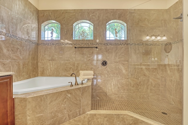 bathroom with vanity and separate shower and tub