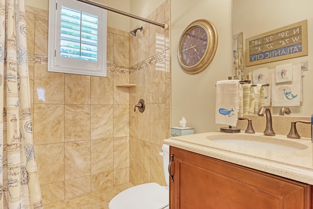 bathroom with curtained shower, vanity, and toilet