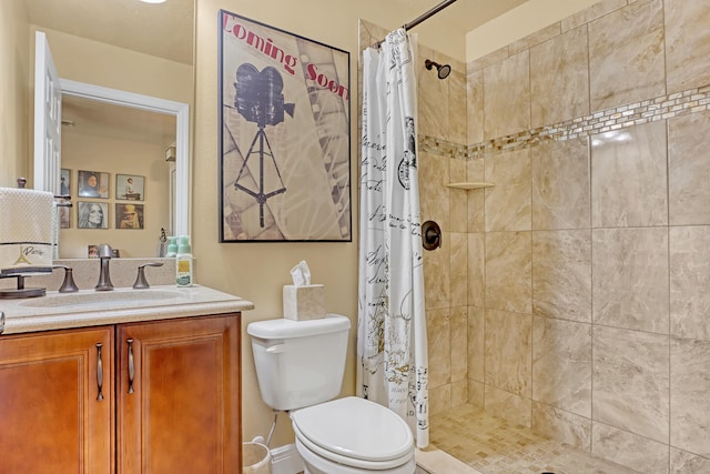 bathroom with vanity, toilet, and curtained shower