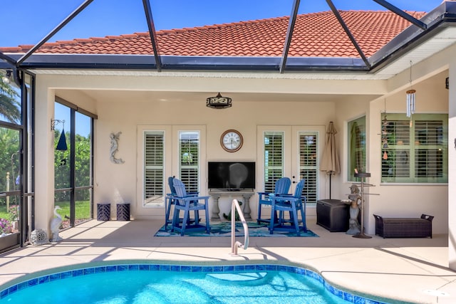 view of pool featuring a patio and glass enclosure