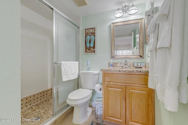 bathroom with a notable chandelier, toilet, walk in shower, and vanity