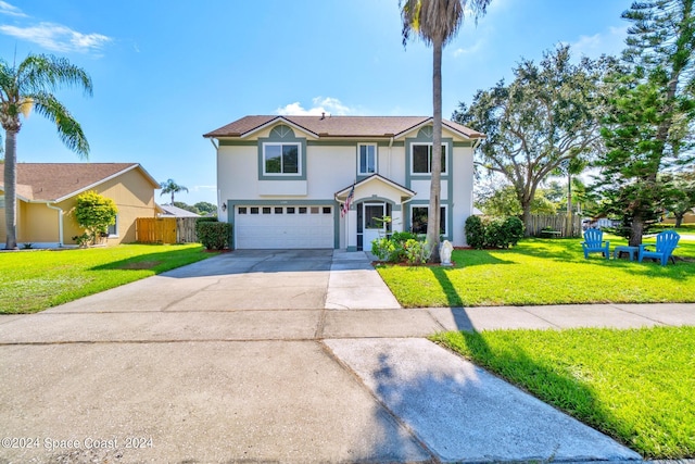 traditional-style house with concrete driveway, fence, a front lawn, and an attached garage