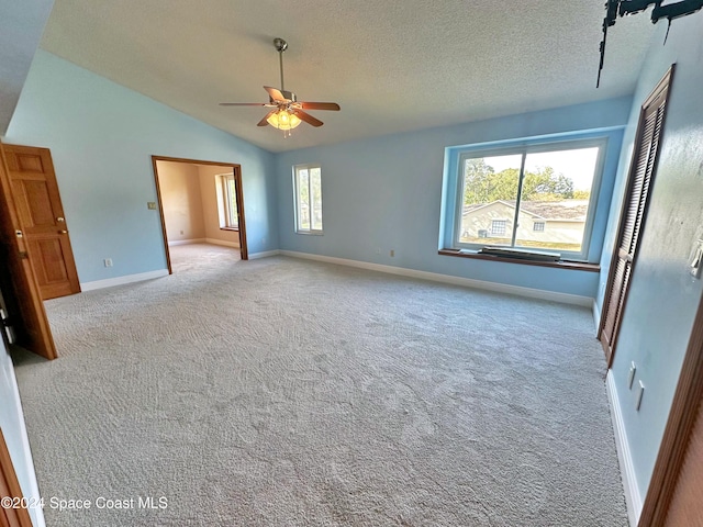 1248 Water Lily Ln, Rockledge, FL 32955 - carpeted spare room with a ceiling fan, vaulted ceiling, and a textured ceiling