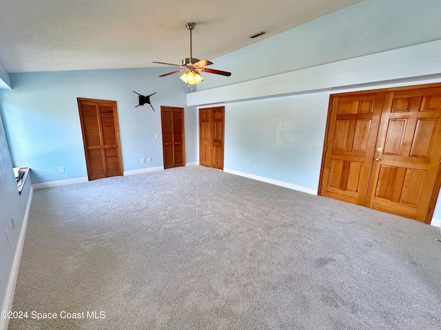 1248 Water Lily Ln, Rockledge, FL 32955 - unfurnished bedroom featuring carpet floors, high vaulted ceiling, ceiling fan, and two closets