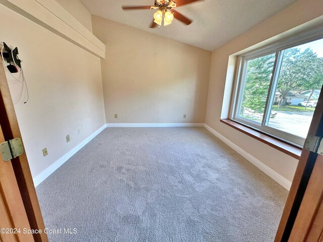 1248 Water Lily Ln, Rockledge, FL 32955 - spare room featuring vaulted ceiling, carpet, and a ceiling fan