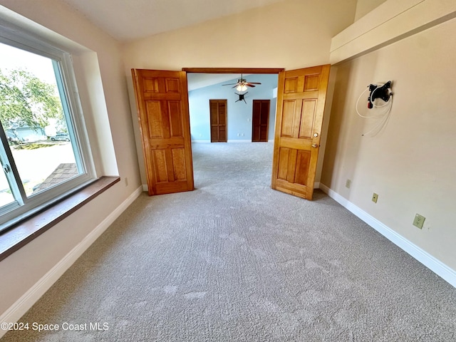 1248 Water Lily Ln, Rockledge, FL 32955 - unfurnished room featuring vaulted ceiling, light carpet, and a ceiling fan