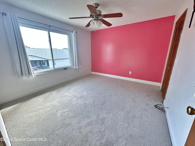 1248 Water Lily Ln, Rockledge, FL 32955 - unfurnished room featuring carpet flooring, a textured ceiling, and a ceiling fan