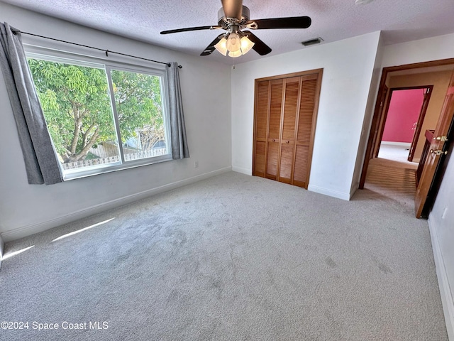 1248 Water Lily Ln, Rockledge, FL 32955 - unfurnished bedroom featuring a textured ceiling, a closet, carpet floors, and ceiling fan