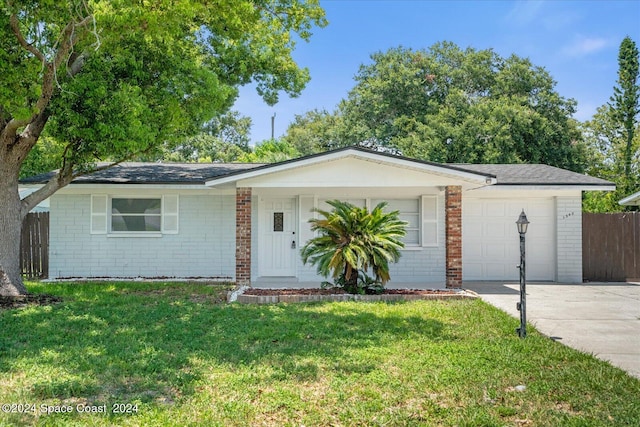 ranch-style house with a garage and a front yard