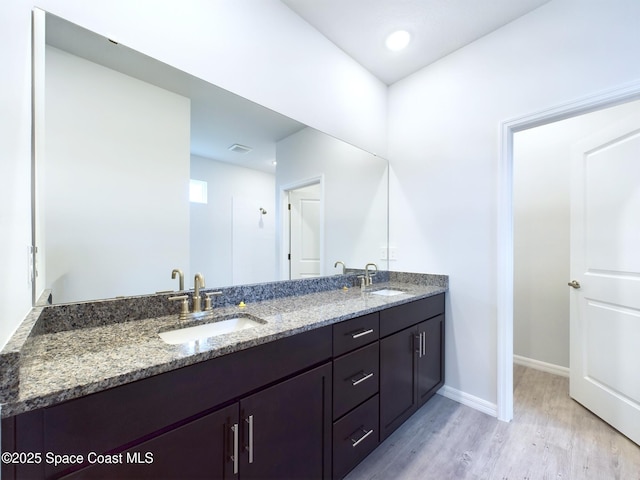 bathroom featuring hardwood / wood-style flooring and vanity