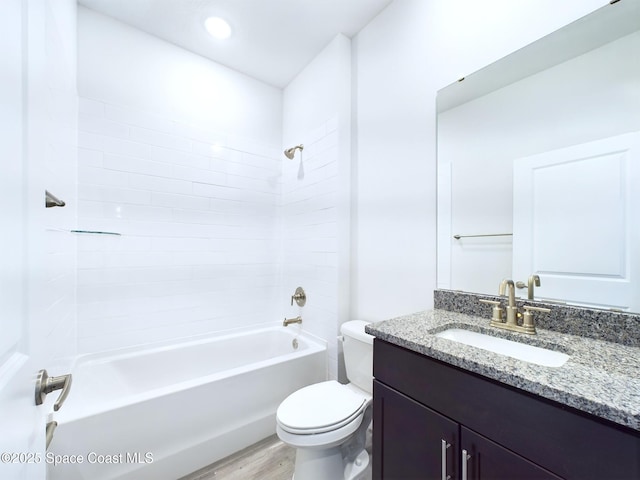 full bathroom with vanity, hardwood / wood-style flooring, bathtub / shower combination, and toilet