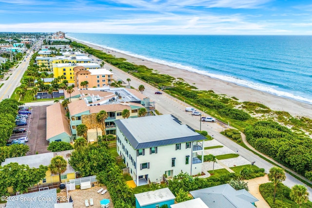 drone / aerial view featuring a view of the beach and a water view