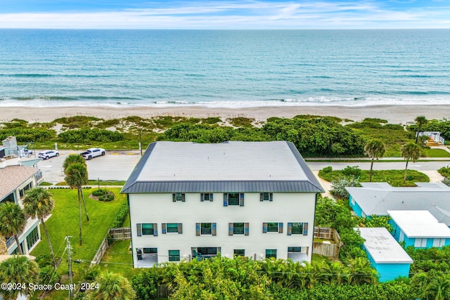 drone / aerial view featuring a water view and a beach view