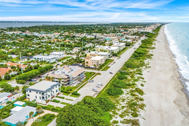 birds eye view of property with a view of the beach and a water view