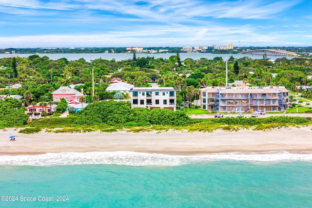 birds eye view of property featuring a water view and a view of the beach